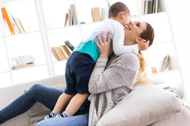 istock Beautiful young mother and her son having fun at home. 680445728