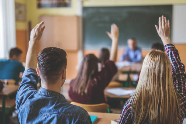 istock Rear view of high school students with raised arms. 680446108