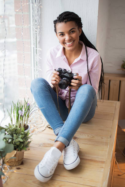 istock Cheerful female photographer looking at camera 680447756