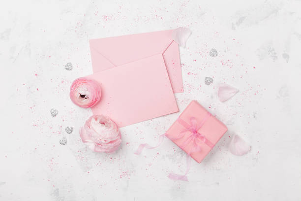 istock Gift or present box, pink paper blank decorated ranunculus flowers. Greeting mockup concept. Flat lay. 680461206