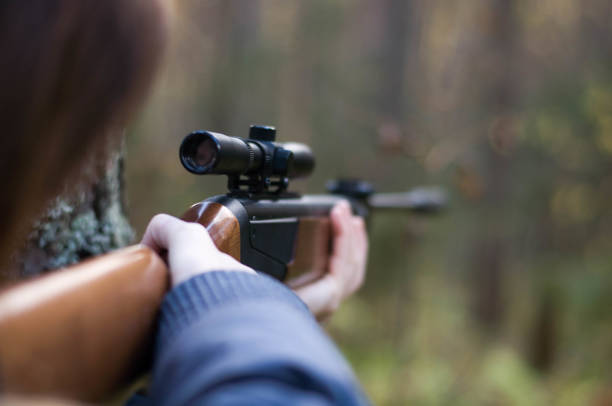 istock Young pretty girl with rifle 680464466