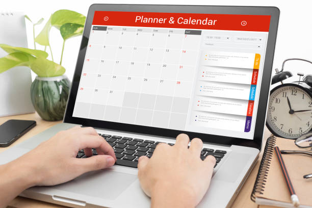 istock business hand typing on a laptop keyboard with Calender Planner homepage on the computer screen. organization management remind concept. 680470744