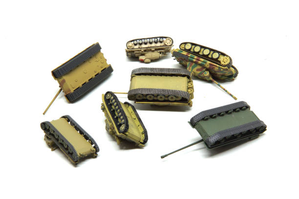 istock Clash of old toy tanks isolated on white background. 680471006