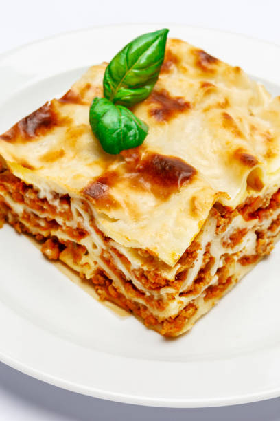 istock Portion of tasty lasagna isolated on white 680472038