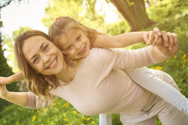 istock Mother and daughter outdoors in a meadow. 680478520