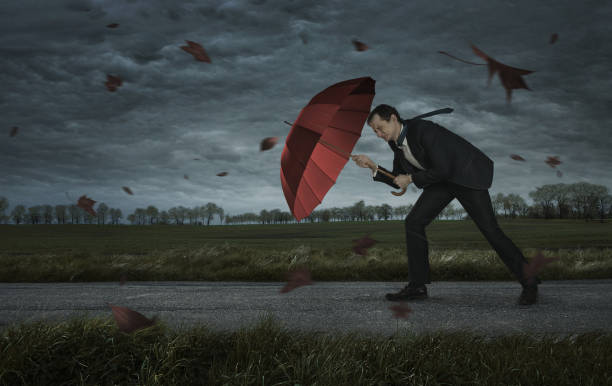 Problems concept Crisis, trouble, problems concept. Businessman walks in the storm with copy space umbrella photos stock pictures, royalty-free photos & images