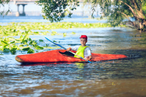 man paddling in kayak is on a river, kayaking