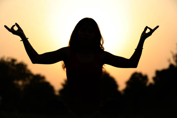 Young women doing meditation Young women doing meditation during sunset time. handspring stock pictures, royalty-free photos & images