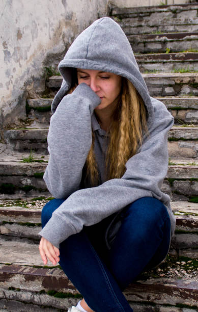 istock Sadness girl sitting on stairs 680484638