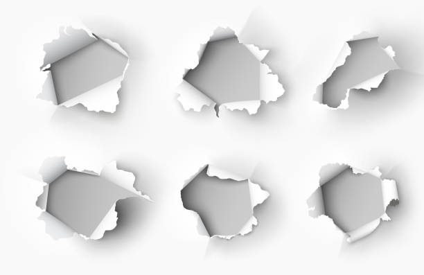 Holes torn in paper on white background Holes torn in paper on white background hole cards stock illustrations