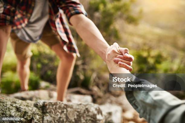 Alone We Climb Rocks Together We Climb Mountains Stock Photo - Download Image Now - Assistance, Hand, Climbing