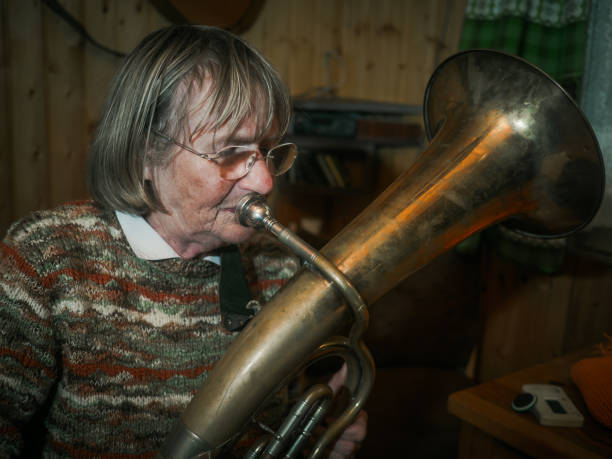 istock Senior woman is playing on a horn 680486926