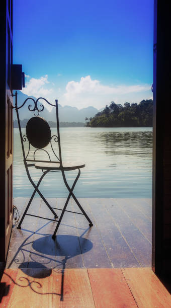 istock Solid chair stand alone in balcony with view of lake side in a sunny day. 680491600