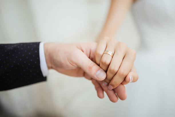 istock Wedding moments. Newly wed couple's hands with wedding rings 680493740