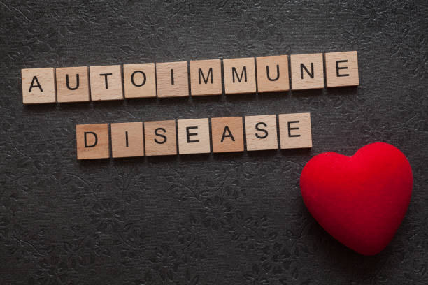 Autoimmune disease The word autoimmune disease formed with wooden letters and a heart on dark background autoantibody stock pictures, royalty-free photos & images