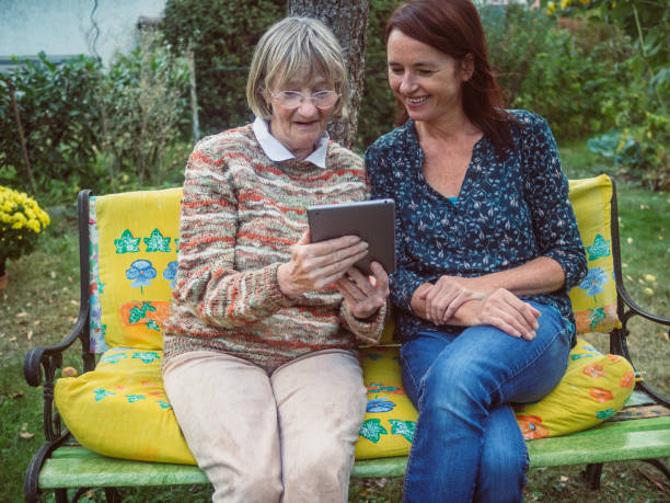 istock Two women using a tablet in the garden 680500940