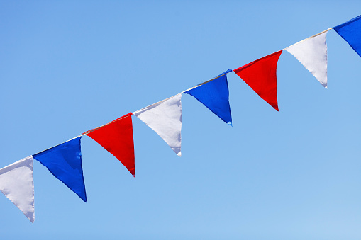 red, white and blue flags on a blue sky background