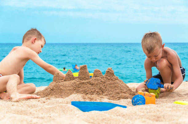 istock Children build a sand castle on the beach 680507594