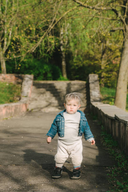 istock Little boy walking by himself in the park 680508188