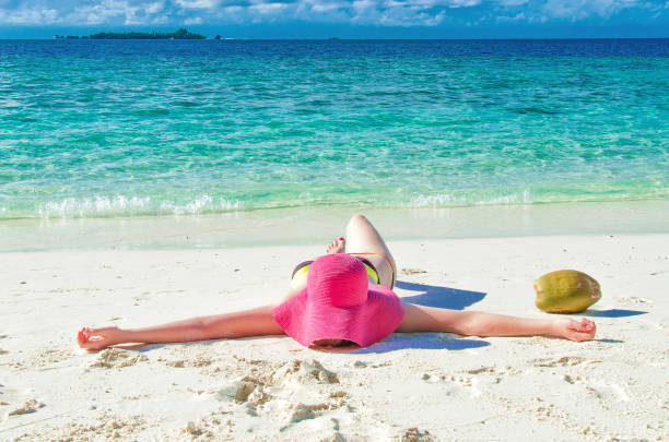 istock Girl sunbathing lying on the sand 680508340