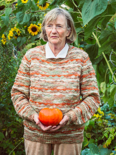 istock Senior woman is holding a pumpkin 680510856