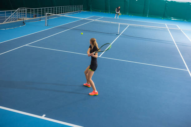 a menina na quadra de tênis fechada com bola - tennis court indoors net - fotografias e filmes do acervo