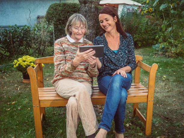 istock Two women using a tablet in the garden 680511702