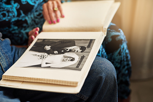 Cropped shot of a senior couple looking through a photo album together at home