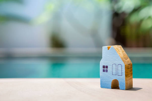 istock Wooden blue house over blurred swimming pool background 680513348