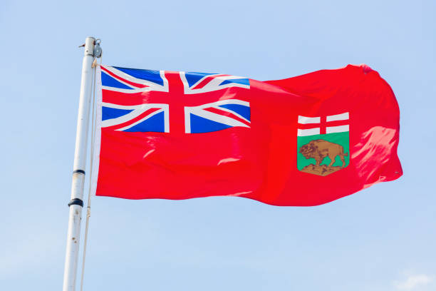 istock Manitoba flag against blue sky 680514818
