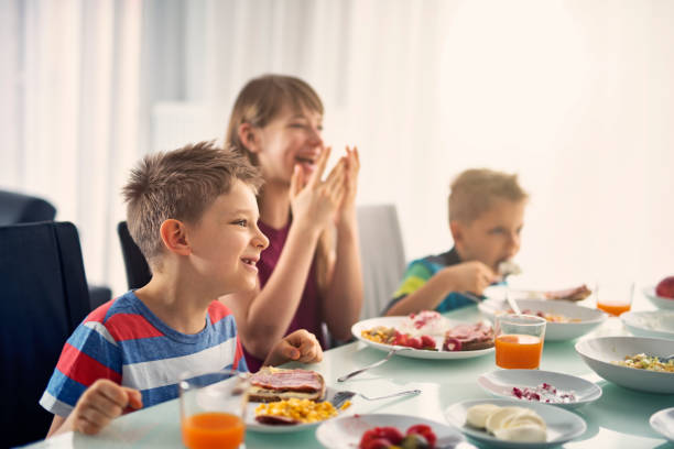 istock Kids eating breakfast on sunny morning 680523630