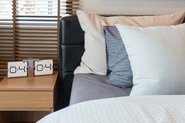 istock modern alarm clock on wooden table side in modern bedroom 680529932