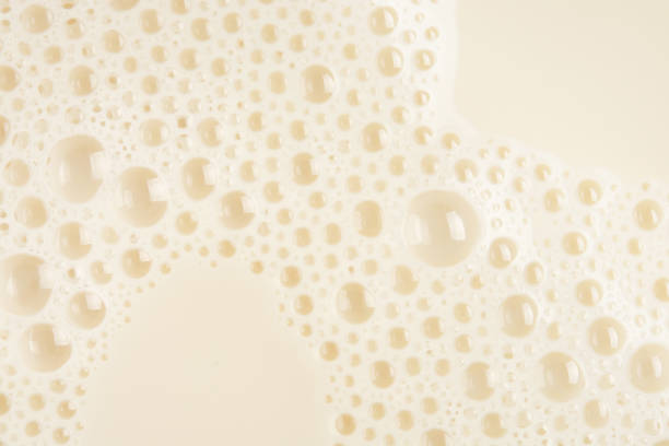istock Soy milk bubble foam background on top view close up 680530232