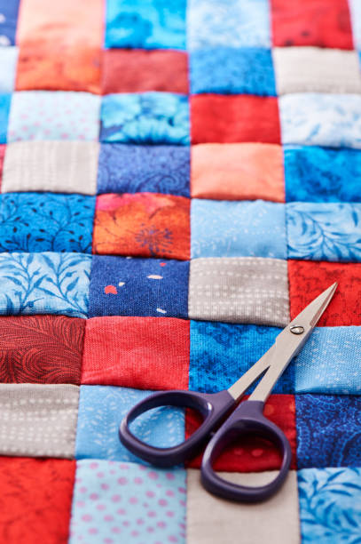 istock Blue and red square pieces of fabric sewn together 680541896