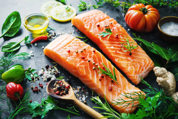 istock Fresh salmon fillet with aromatic herbs, spices and vegetables 680547250