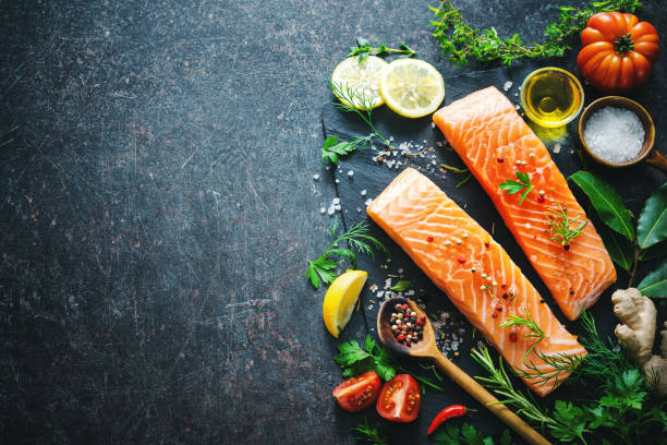 istock Fresh salmon fillet with aromatic herbs, spices and vegetables 680547254