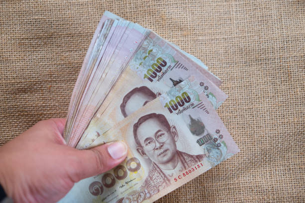 istock Hand holding Thai money, Thai Money 1000 Bath 680548360