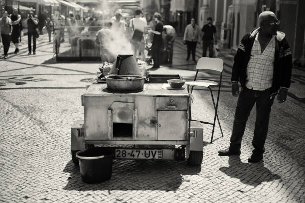 Lisbon, Portugal - April 27, 2017: A traditional roasted chestnuts seller waits for clients in the Rua Augusta in Lisbon downtown.