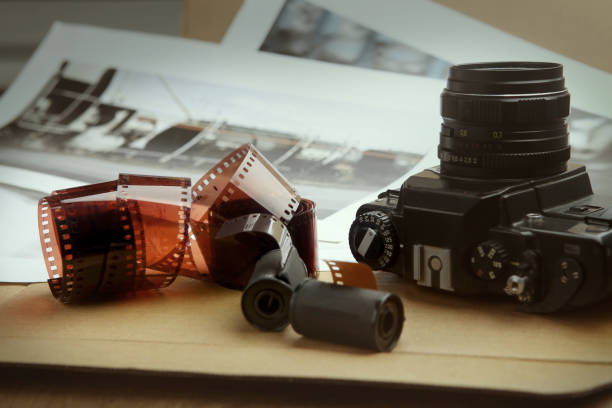 istock Photographic film rolls, cassettes and camera. 680588160
