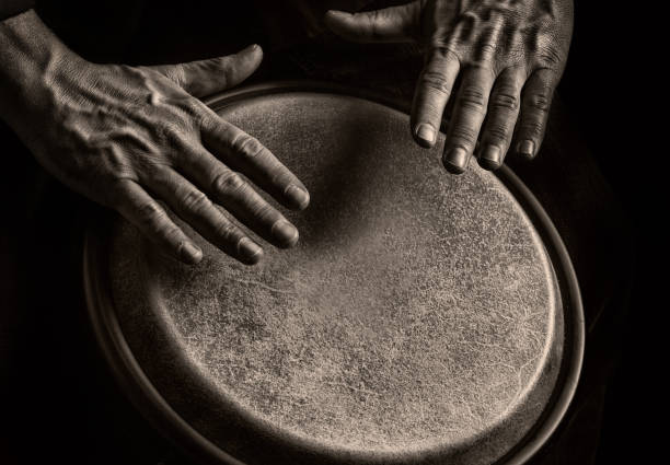 Bongo PLayer in Sephia tone Sephia toned Picture of a bongo player. Detail of the Hands of the Musician percussion instrument stock pictures, royalty-free photos & images