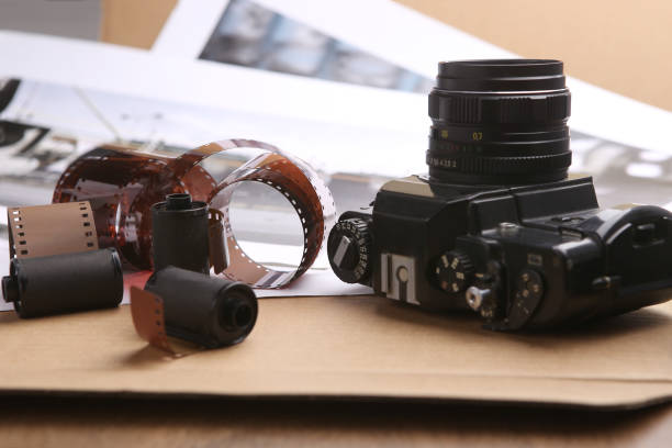 istock Photographic film rolls, cassettes and camera. 680599626