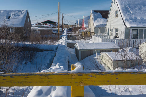 Inuvik, Northwest Territories, Canada - March 28, 2017:  typical housing as seen in Inuvik showing the above ground utility lines in the back of the houses
