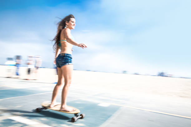 Couple in LA - riding three wheel bicycle and doing skateboarding