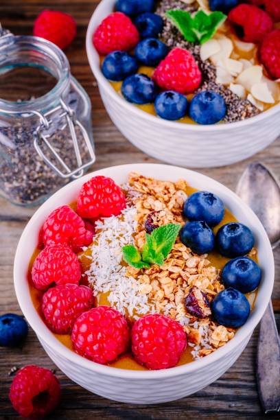 istock Peach smoothie bowls with raspberries, blueberries, chia seeds and granola 680653714