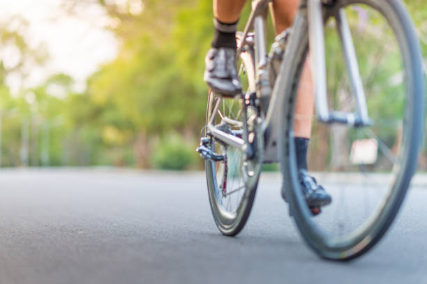 Young asian man Cyclist riding fitness mountain bike on trail at moring street