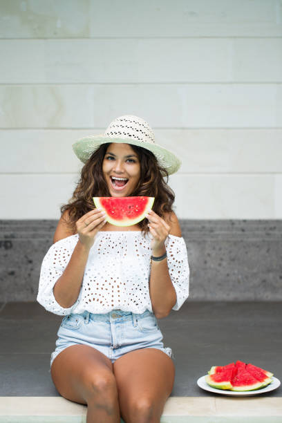 istock Young Beautiful Woman Eating Watermelon 680658040