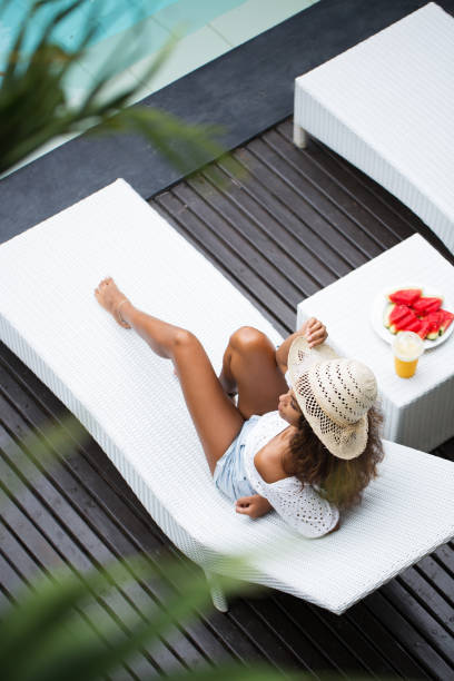 istock Young Beautiful Woman Lying on Chaise Longue 680658100