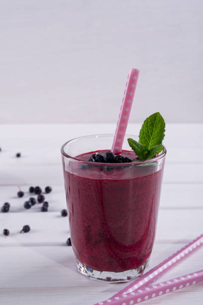 istock Blueberry smoothie with a straw and sprig of mint 680661556