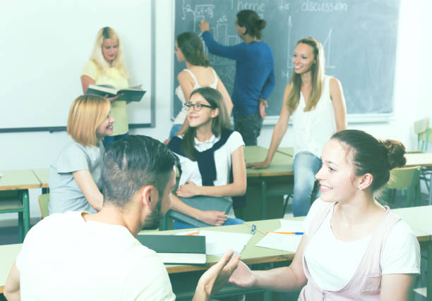 istock students chatting and smiling at the college 680668824