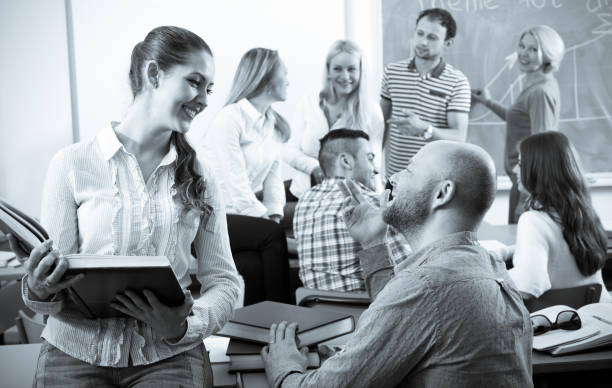 istock Teacher and happy adult students 680672510